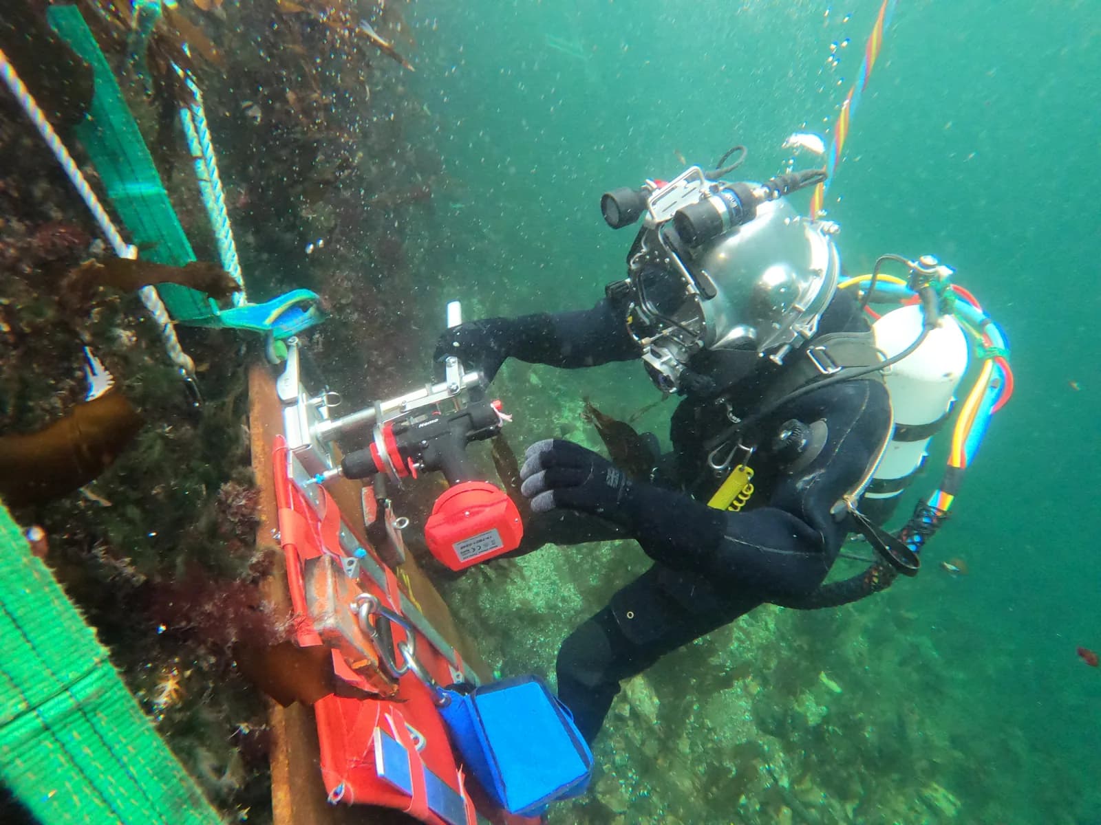 Diver installing Miko Marine equipment on a vessel hull